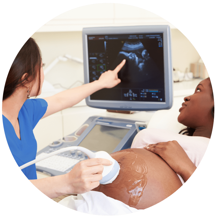 pregnant woman having an ultrasound scan done by a medical professional